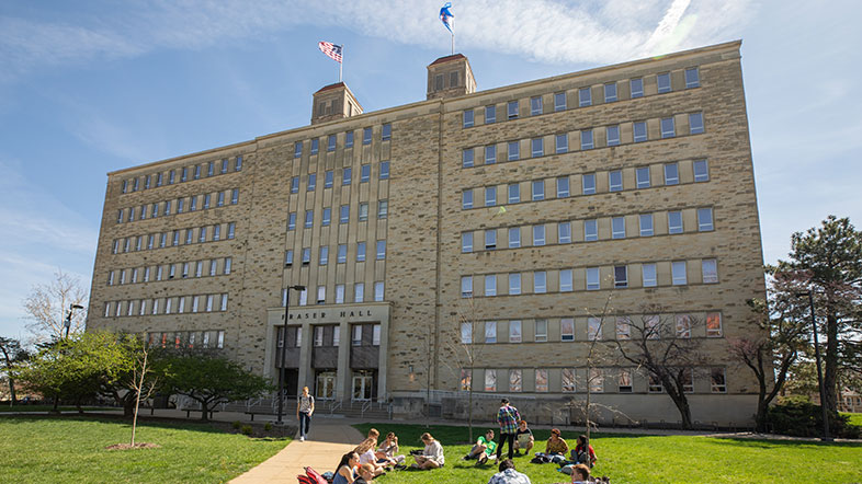 Fraser Hall with students in a class on the lawn