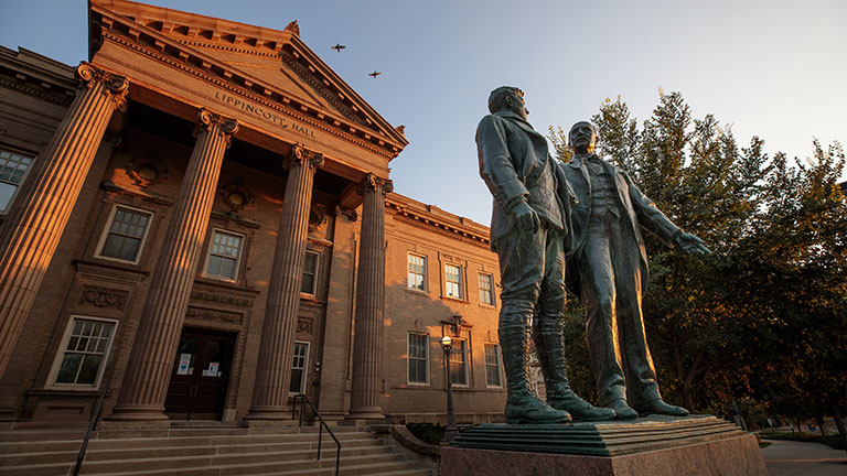 Lippincott Hall with the statues in front in the early morning light